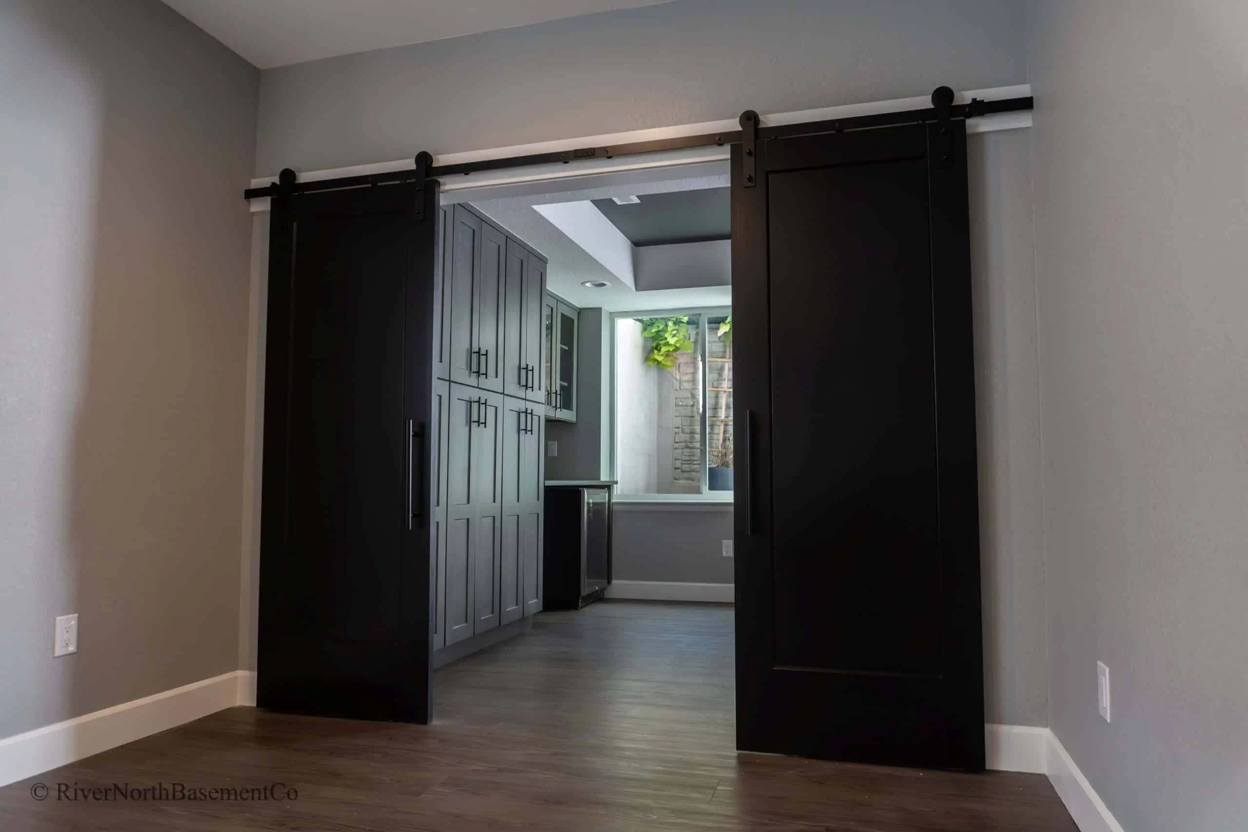 Custom basement bar and media room designed for a Denver family home